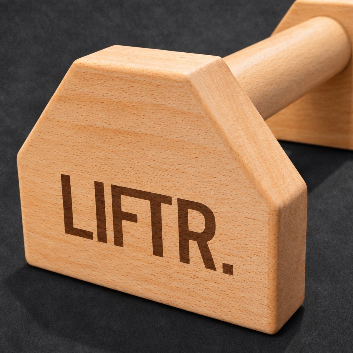 Close-up of the LIFTR logo and wooden parallette finish