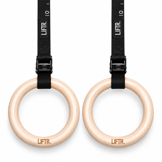 Pair of LIFTR 32mm wooden gymnastic rings with numbered black buckle straps